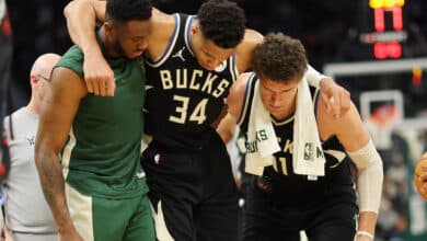MILWAUKEE, WISCONSIN - APRIL 09: Giannis Antetokounmpo #34 of the Milwaukee Bucks is helped off the court by Thanasis Antetokounmpo #43 and Brook Lopez #11 after suffering an injury during the second half of a game against the Boston Celtics at Fiserv Forum on April 09, 2024 in Milwaukee, Wisconsin.