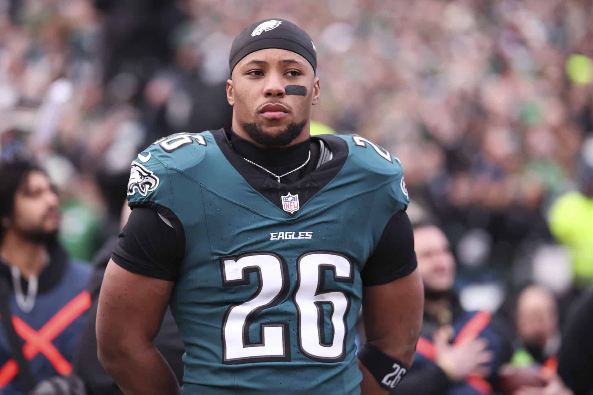 Saquon Barkley #26 of the Philadelphia Eagles stands on the field in the NFC Championship Game against the Washington Commanders
