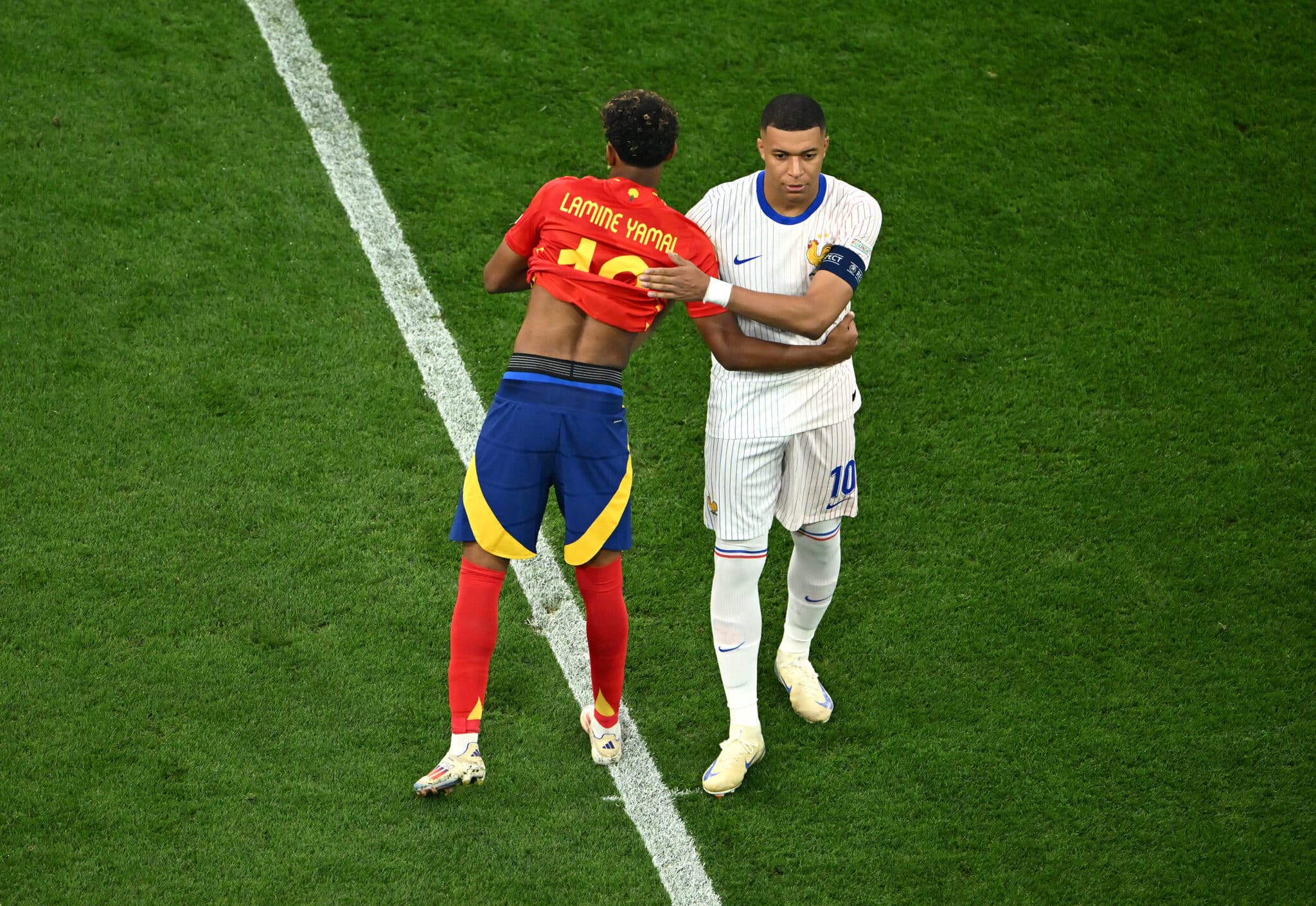 Nations League: Lamine Yamal of Spain embraces Kylian Mbappe of France prior to the UEFA EURO 2024 Semi-Final match between Spain and France at Munich Football Arena on July 09, 2024 in Munich, Germany.