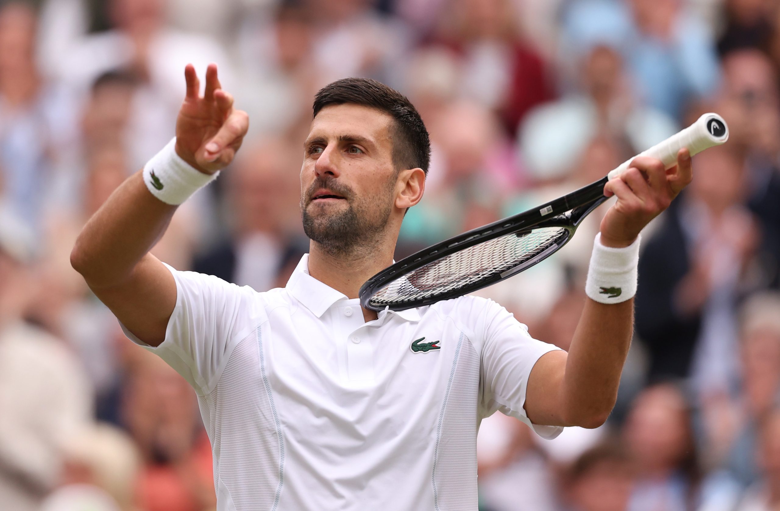 Novak Djokovic of Serbia celebrates winning match point with a violin gesture against Lorenzo Musett