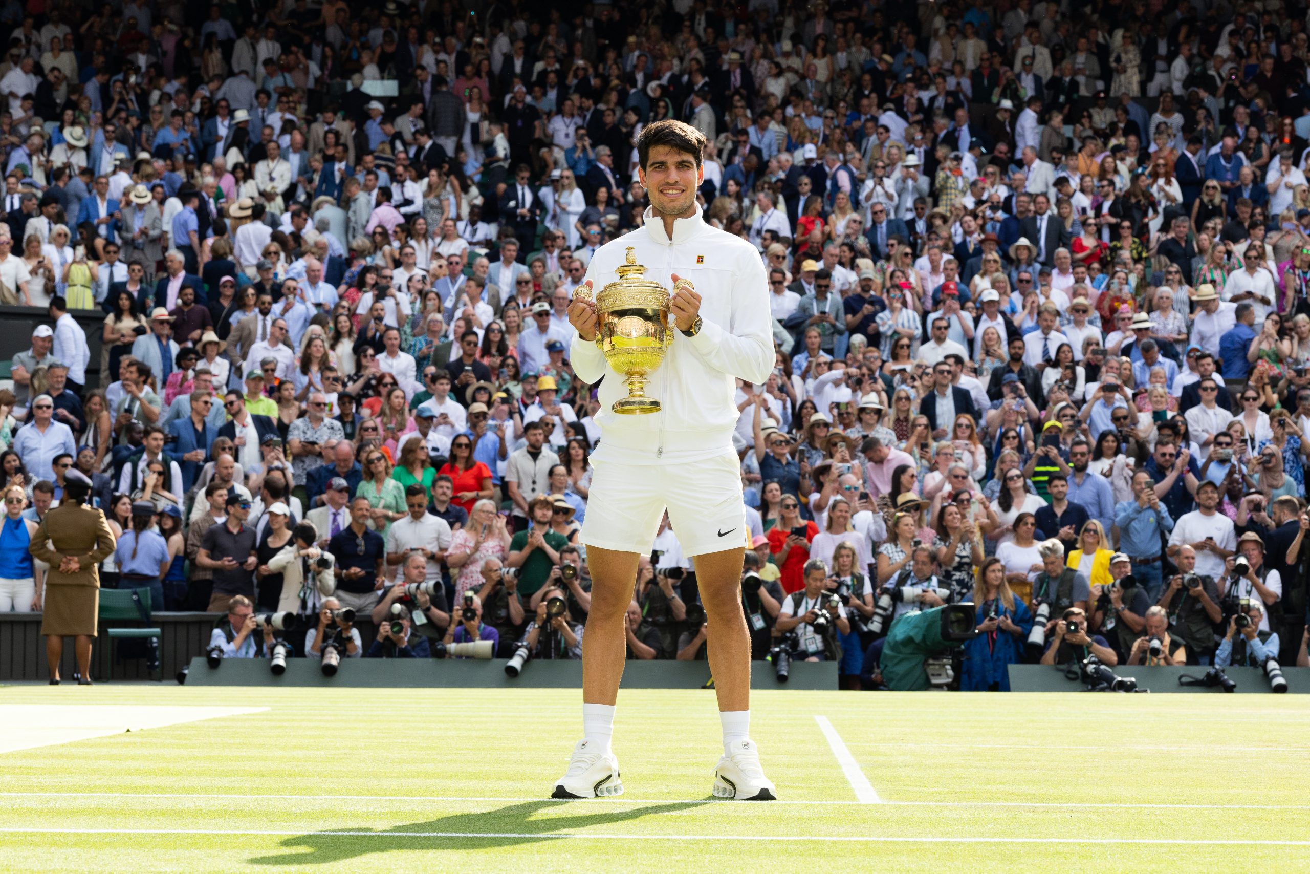 LONDON, ENGLAND - JULY 14: Carlos Alcaraz of Spain holds the trophy after defeating Novak Djokovic of Serbia at the Mens Singles Final against at The Wimbledon Lawn Tennis Championship at the All England Lawn and Tennis Club at Wimbledon on July 14th, 2024 in London, England.
