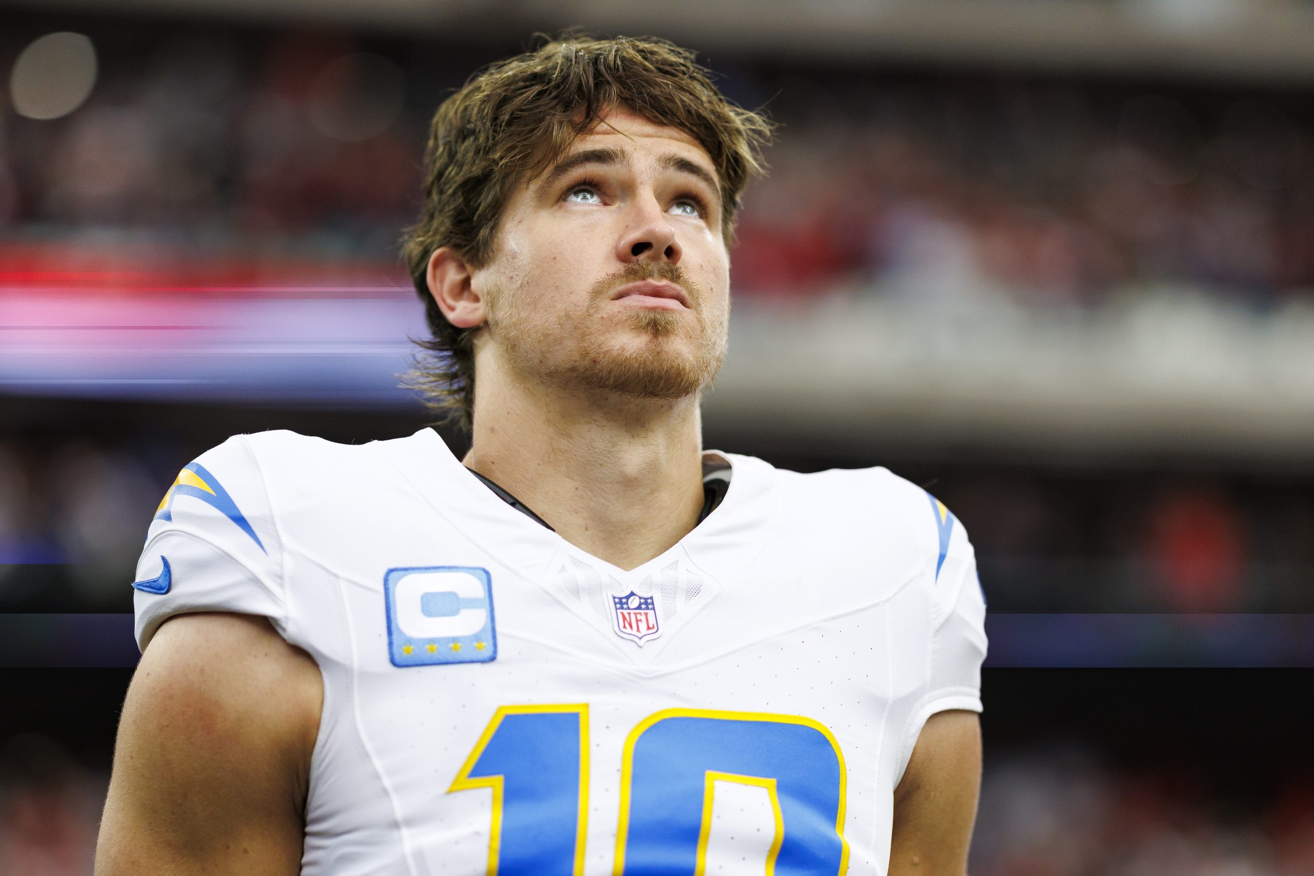 HOUSTON, TEXAS - JANUARY 11: Quarterback Justin Herbert #10 of the Los Angeles Chargers stands on the sidelines during the national anthem prior to an AFC Wild Card game against the Houston Texans, at NRG Stadium on January 11, 2025 in Houston, Texas. (