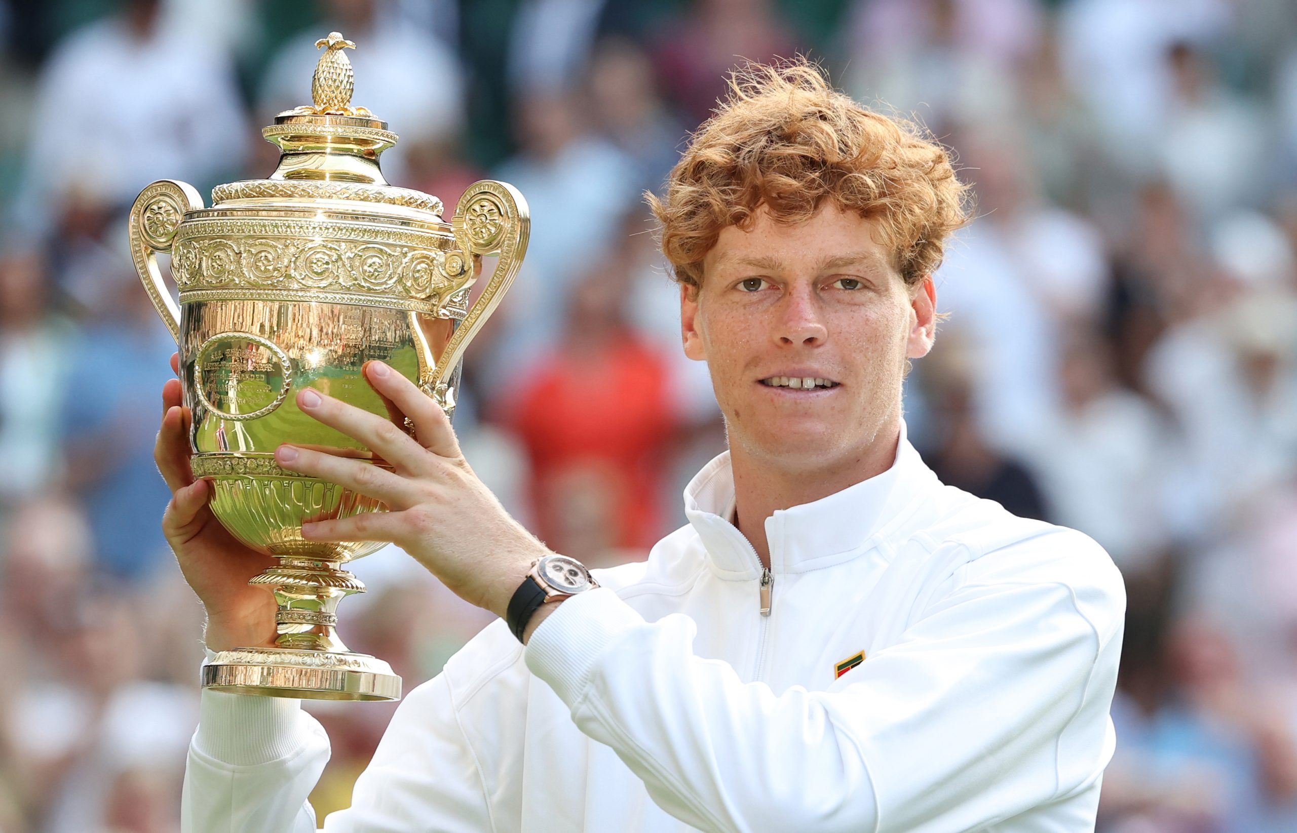LONDON, ENGLAND - JULY 13: Jannick Sinner (ITA) [1] with the winner's trophy after winning his Gentlemen's Singles Final match against Carlos Alcaraz (ESP) [2] during day fourteen of The Championships Wimbledon 2025 at All England Lawn Tennis and Croquet Club on July 13, 2025 in London, England.