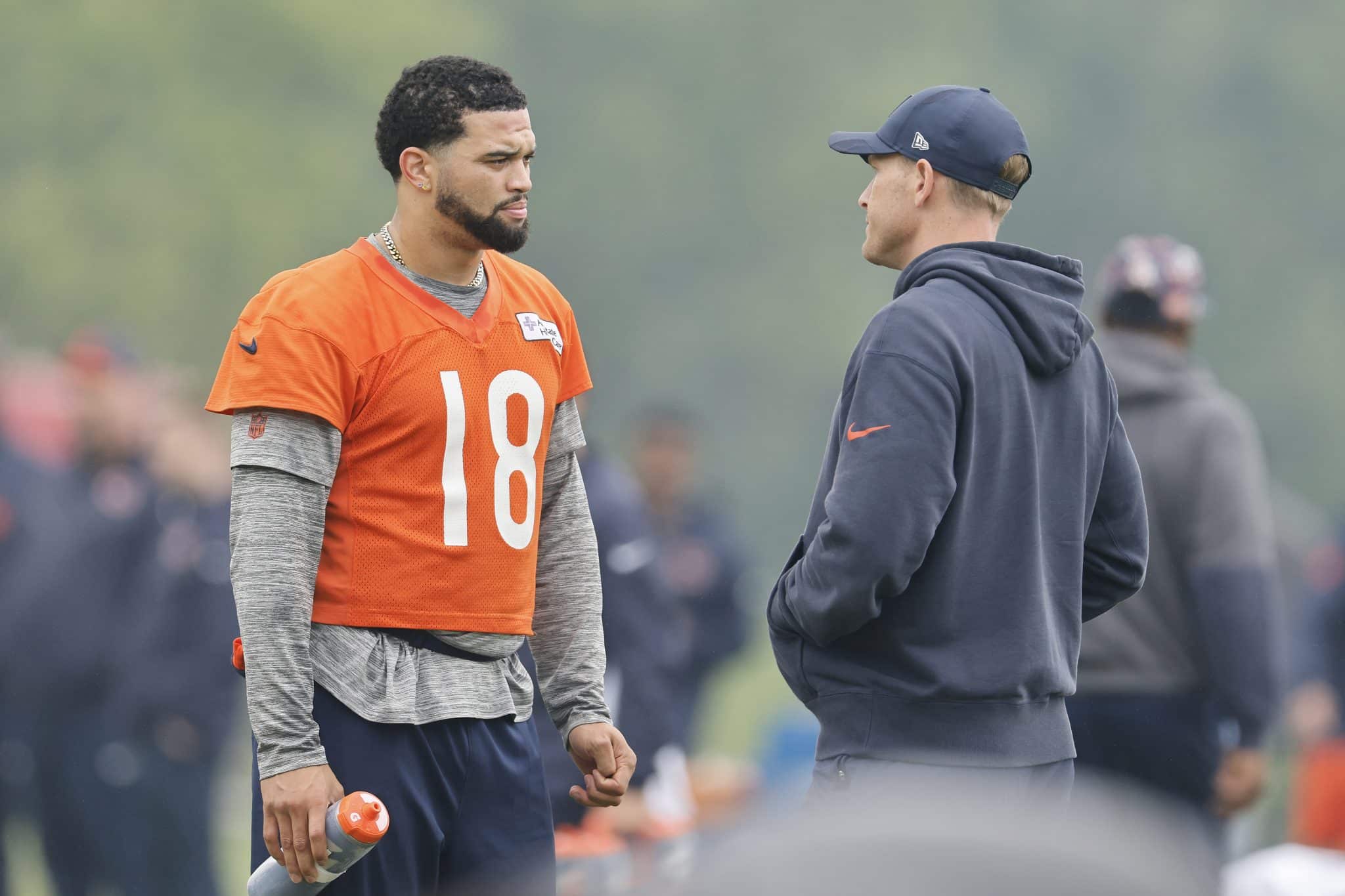 LAKE FOREST, ILLINOIS - JUNE 04: Caleb Williams #18 of the Chicago Bears talks with head coach Ben Johnson during Chicago Bears OTA Offseason Workout at Halas Hall on June 04, 2025 in Lake Forest, Illinois.